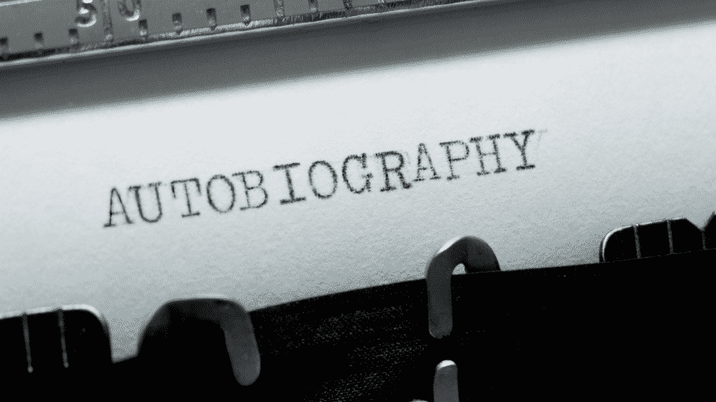 A picture of a white piece of paper in a typewriter written autobiography: How to write an Autobiographical essay